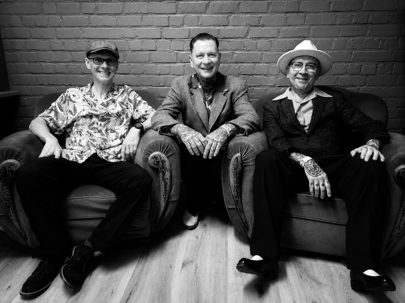Jurgen, Guy and Yves together on a sofa, all three fully in frame